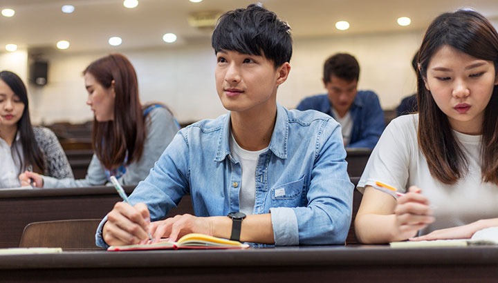 University Student Paying Attention In Class